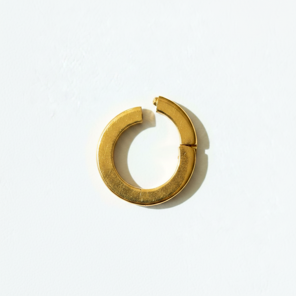 Gold chunky open ring clasp white background